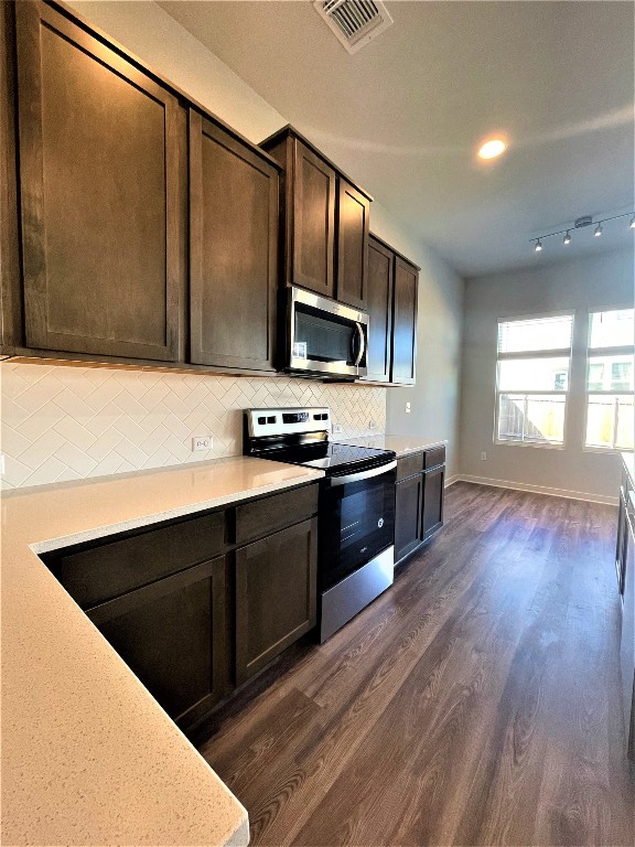 15110 Forum Avenue Pflugerville, TX 78660 - Photo 9 of 29 a kitchen with stainless steel appliances granite countertop a stove a sink and a microwave