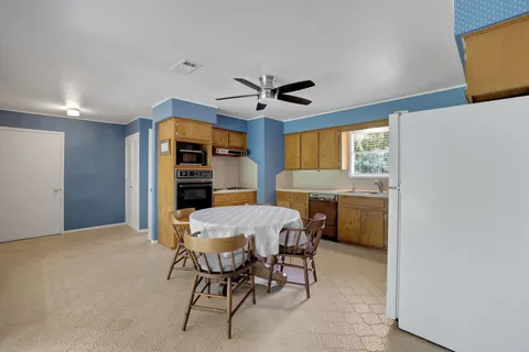 a view of a dining room with furniture and window