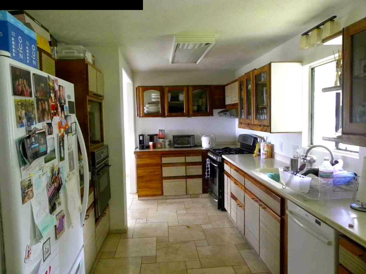 305 Kaupakalua Road Haiku, HI 96708 - Photo 9 of 13 a kitchen with stainless steel appliances a sink and a refrigerator