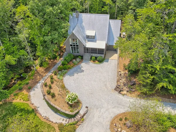 a bedroom with furniture and a large window