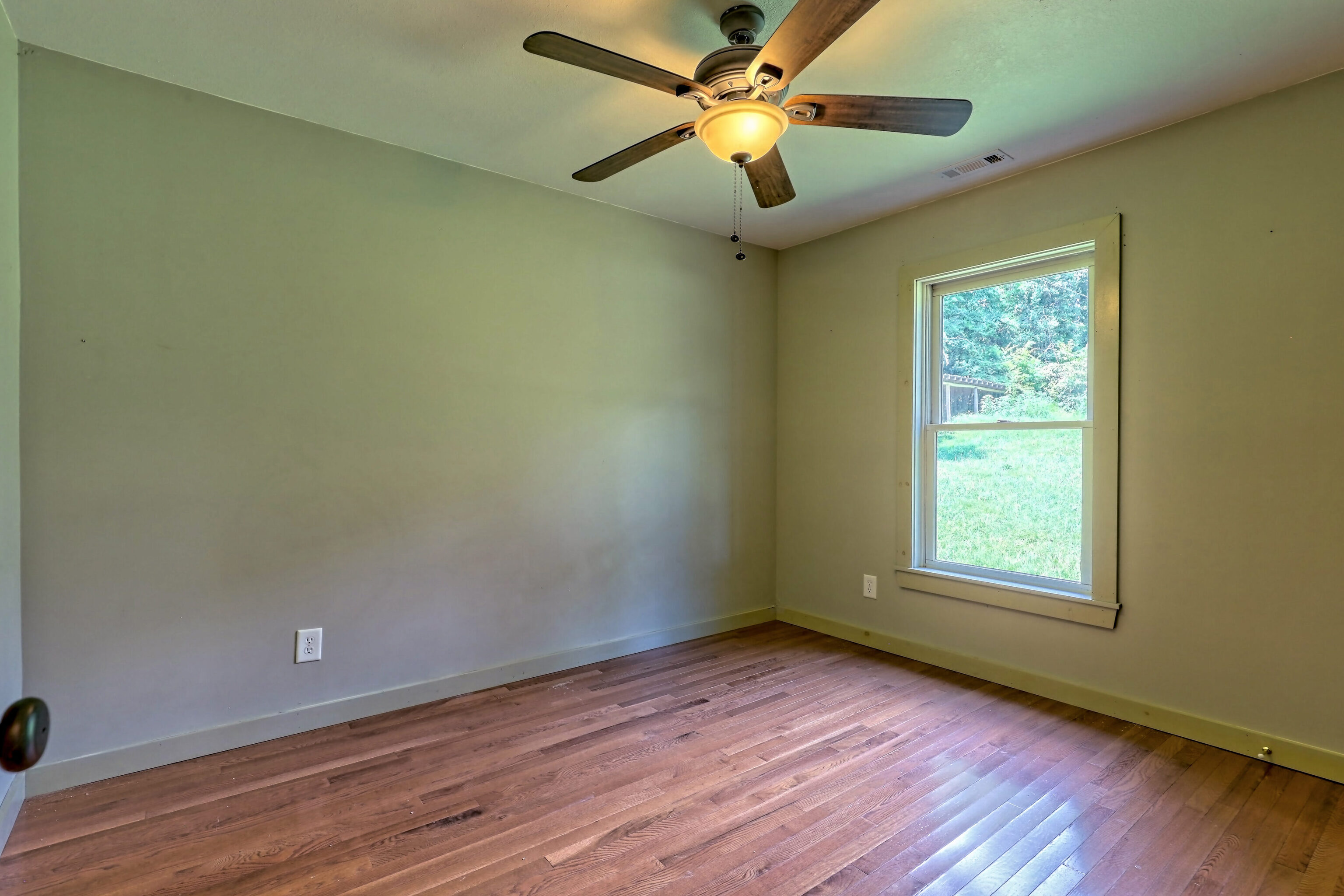 3622 Sandy Ford Road Clayton, GA 30525 - Photo 148 of 182 a view of an empty room with wooden floor and a window