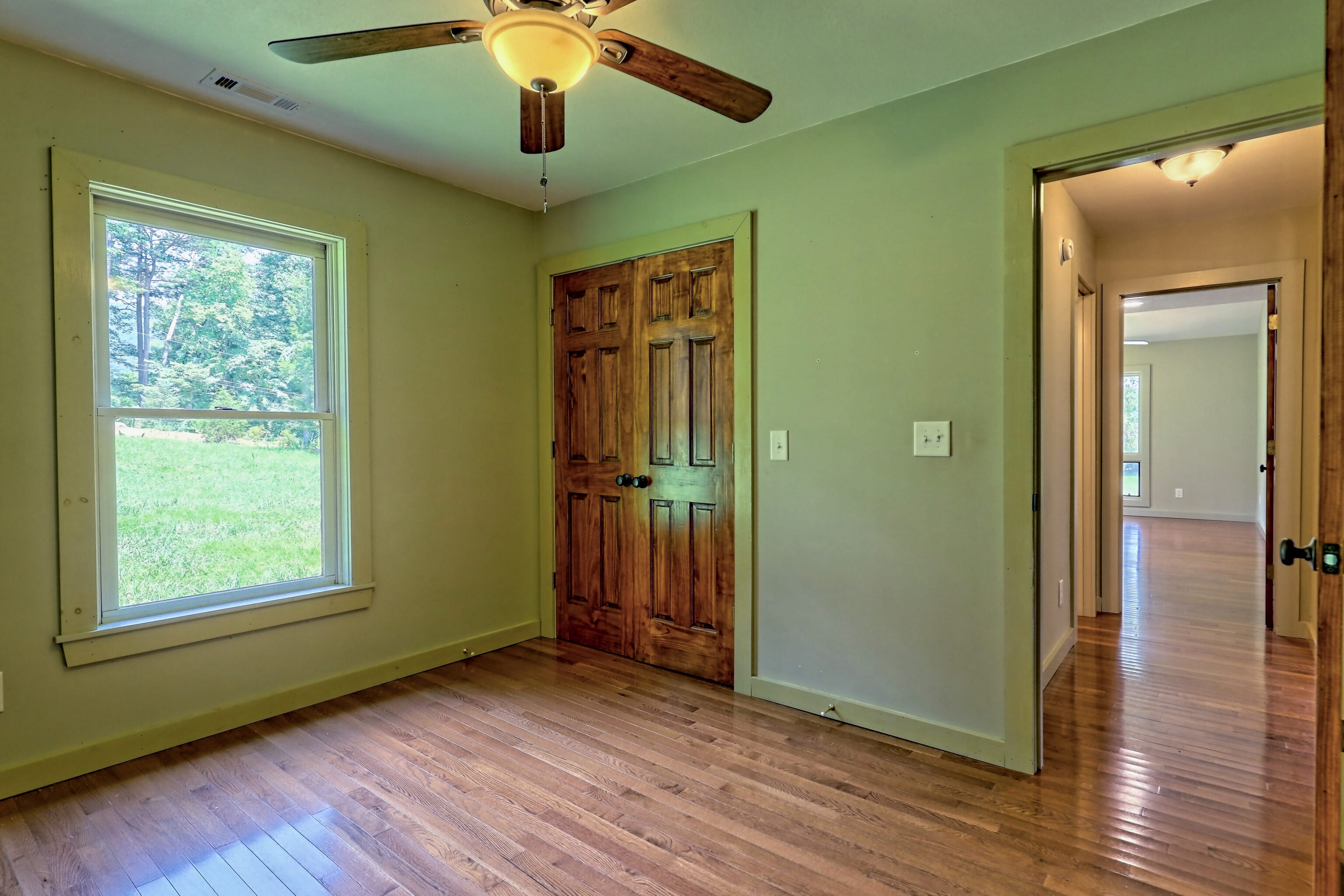 3622 Sandy Ford Road Clayton, GA 30525 - Photo 149 of 182 a view of an empty room with wooden floor and a window