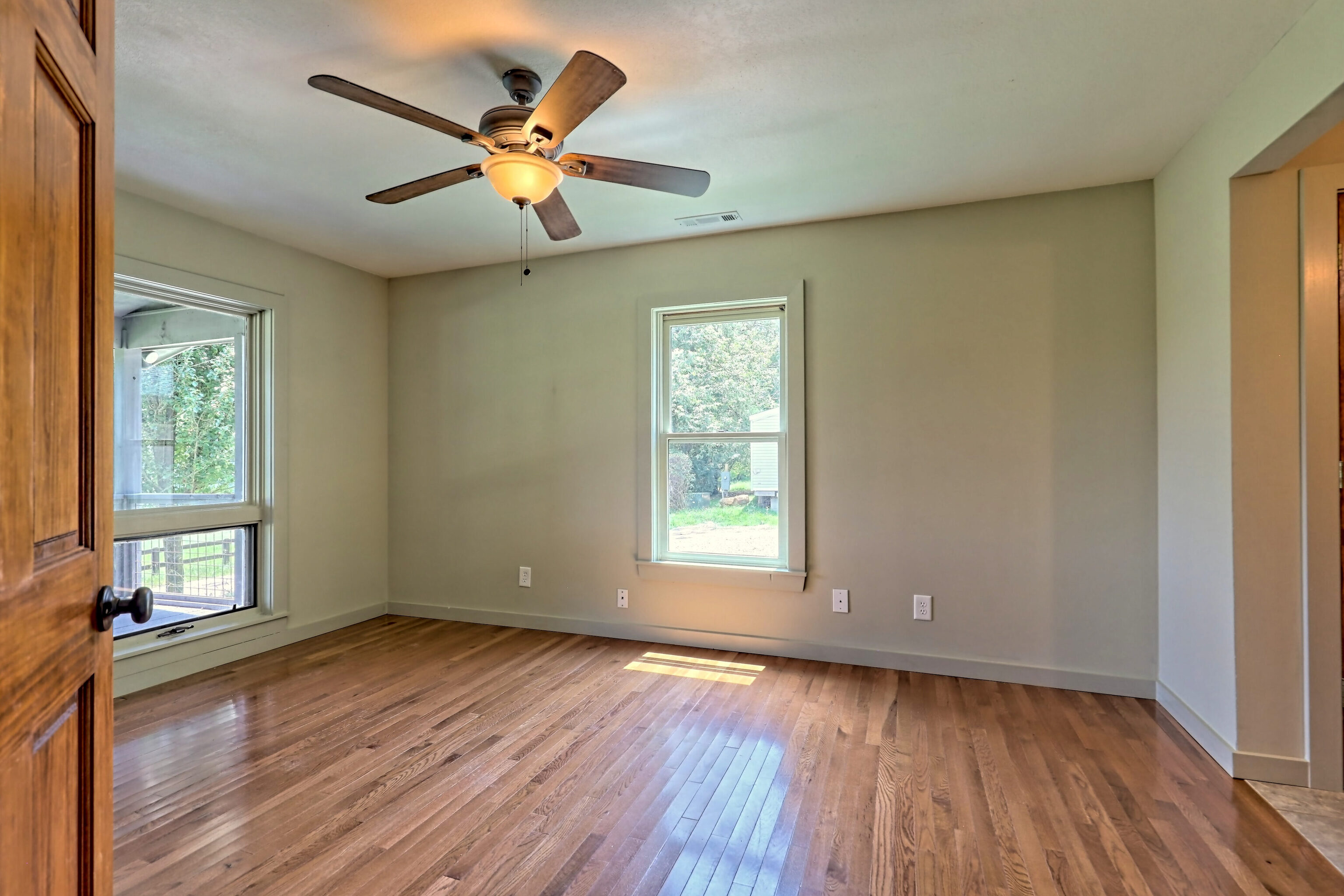 3622 Sandy Ford Road Clayton, GA 30525 - Photo 151 of 182 a view of an empty room with wooden floor and a window
