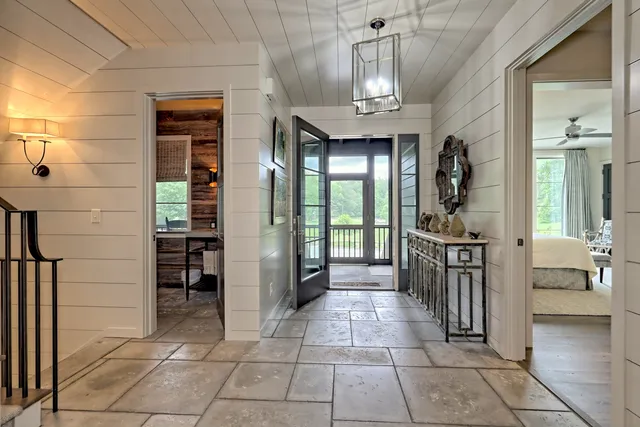 a view of a hallway with wooden floor and a fireplace
