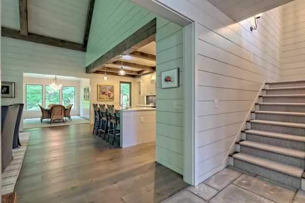 a view of a hallway with wooden floor and entryway