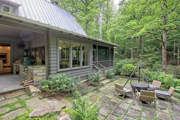 a view of a swimming pool with an outdoor seating and a yard