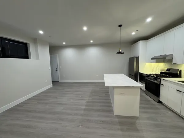 a view of kitchen with sink microwave and refrigerator