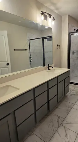 a bathroom with a glass shower door