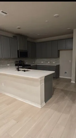 a kitchen with a cabinets and white appliances
