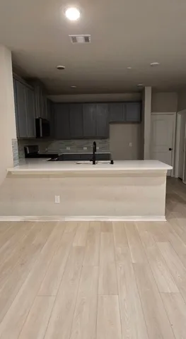 a view of kitchen with stainless steel appliances kitchen island sink refrigerator and stove top oven