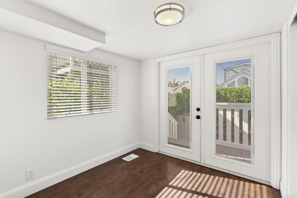 1624 North Coast Highway 101, Unit 2 Encinitas, CA 92024 - Photo 16 of 43 an empty room with wooden floor and windows