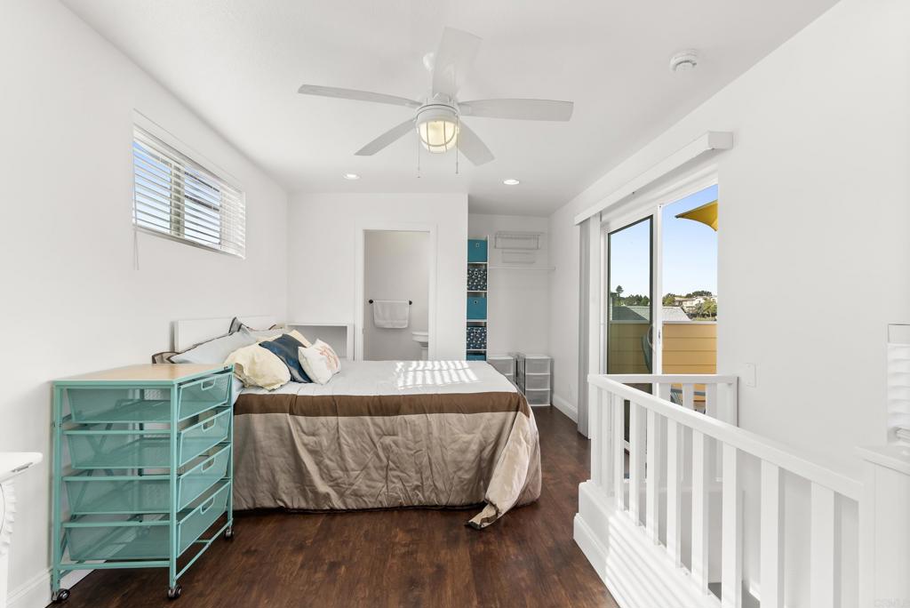 1624 North Coast Highway 101, Unit 2 Encinitas, CA 92024 - Photo 21 of 43 a living room with a bed furniture and a large window