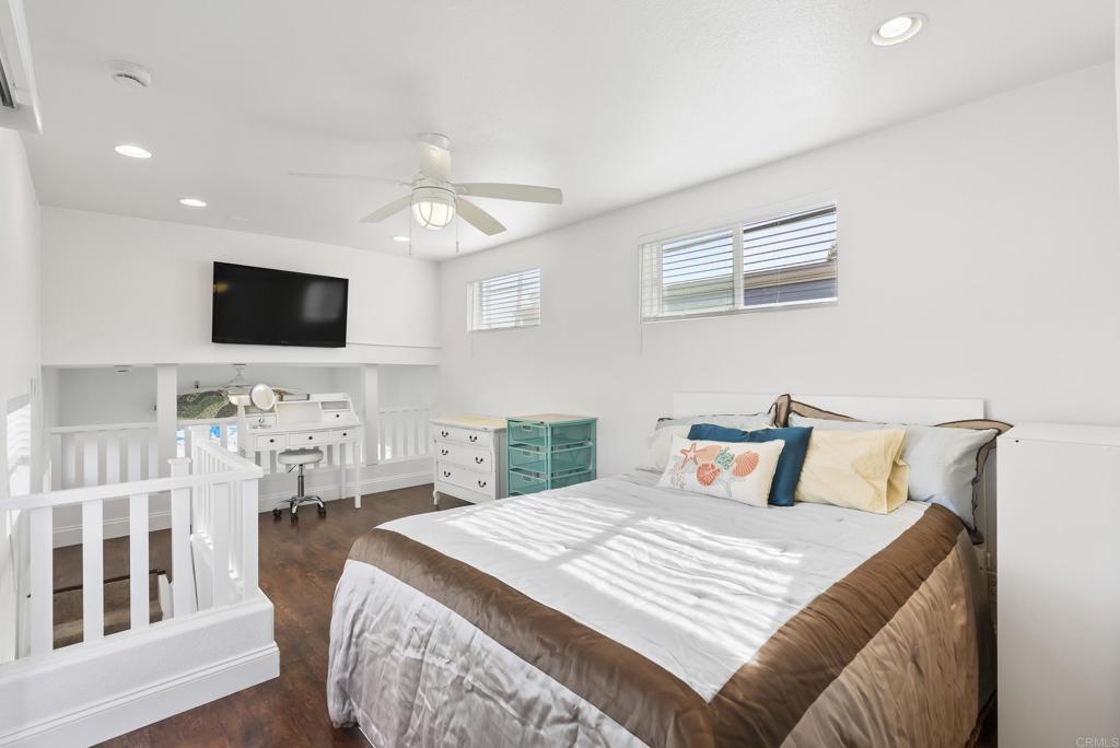 1624 North Coast Highway 101, Unit 2 Encinitas, CA 92024 - Photo 23 of 43 a bedroom with a bed and a flat screen tv