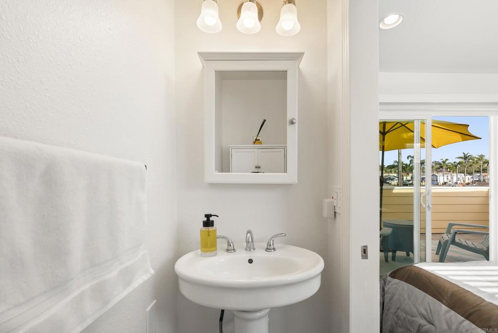 1624 North Coast Highway 101, Unit 2 Encinitas, CA 92024 - Photo 24 of 43 a bathroom with a sink and a mirror