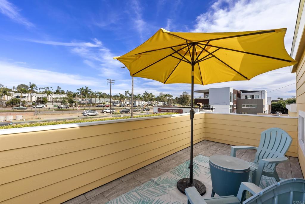 1624 North Coast Highway 101, Unit 2 Encinitas, CA 92024 - Photo 25 of 43 a view of a terrace with furniture and umbrella