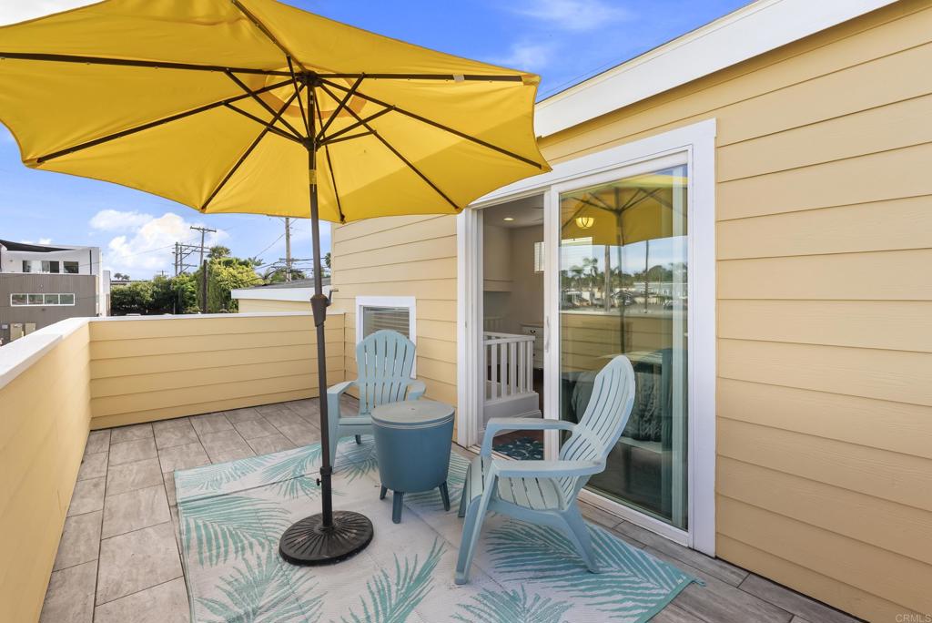 1624 North Coast Highway 101, Unit 2 Encinitas, CA 92024 - Photo 27 of 43 a view of a street with chairs under an umbrella