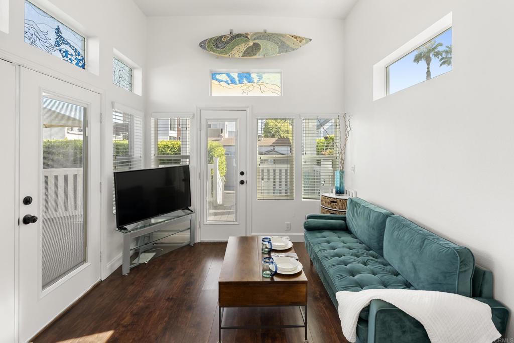 1624 North Coast Highway 101, Unit 2 Encinitas, CA 92024 - Photo 9 of 43 a living room with furniture a flat screen tv and a window