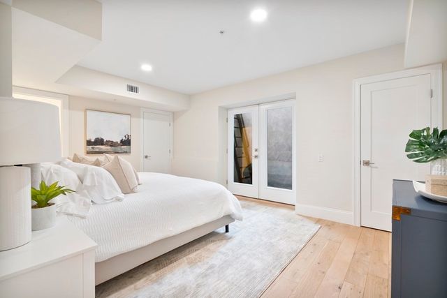 a bedroom with a bed and a potted plant