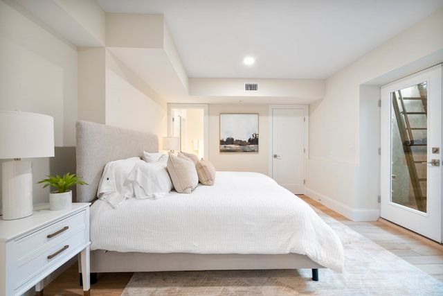a large white bed in a white room