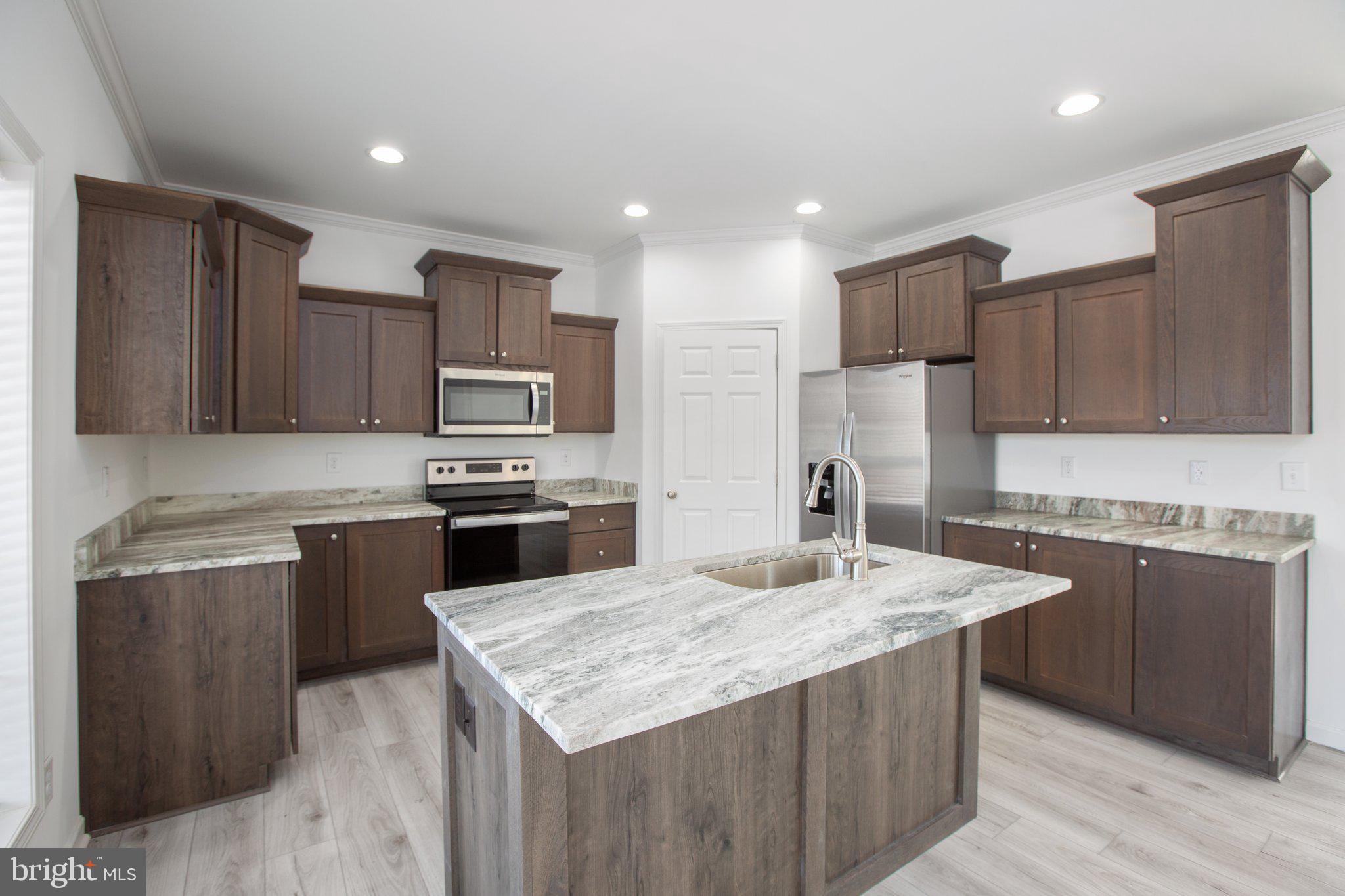 1005 Levi Road Green Bay, VA 23942 - Photo 12 of 34 a kitchen with kitchen island granite countertop stainless steel appliances and wooden cabinets