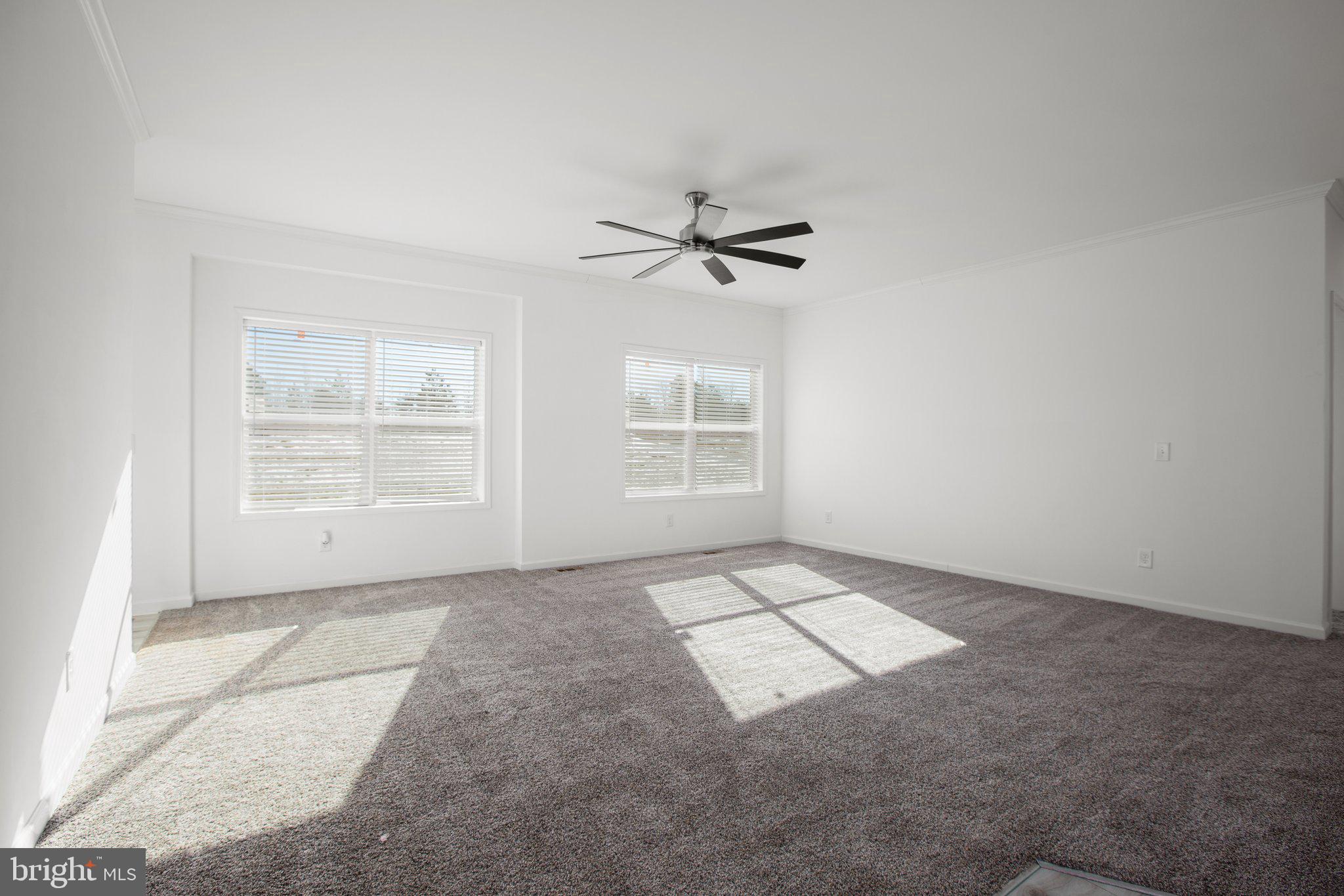 1005 Levi Road Green Bay, VA 23942 - Photo 7 of 34 an empty room with windows and chandelier fan