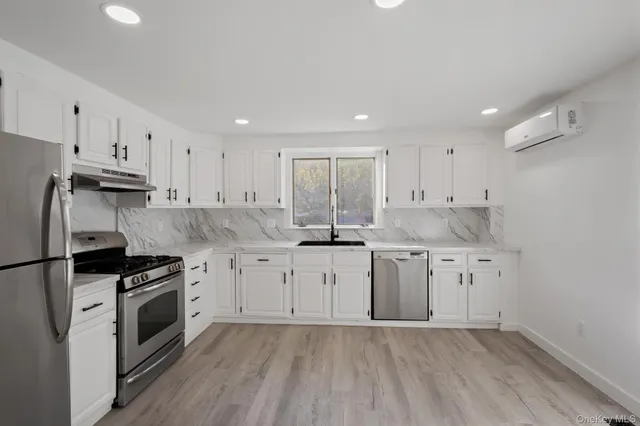 a kitchen with granite countertop cabinets stainless steel appliances a sink and a counter top space