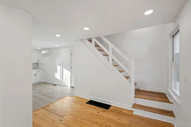 a view of entryway and hall with wooden floor