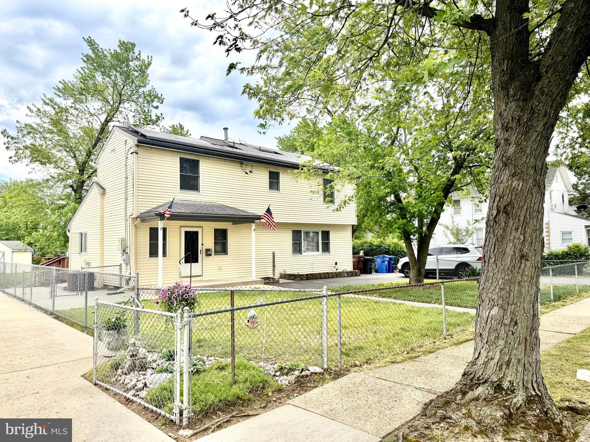 a front view of a house with swimming pool and a yard