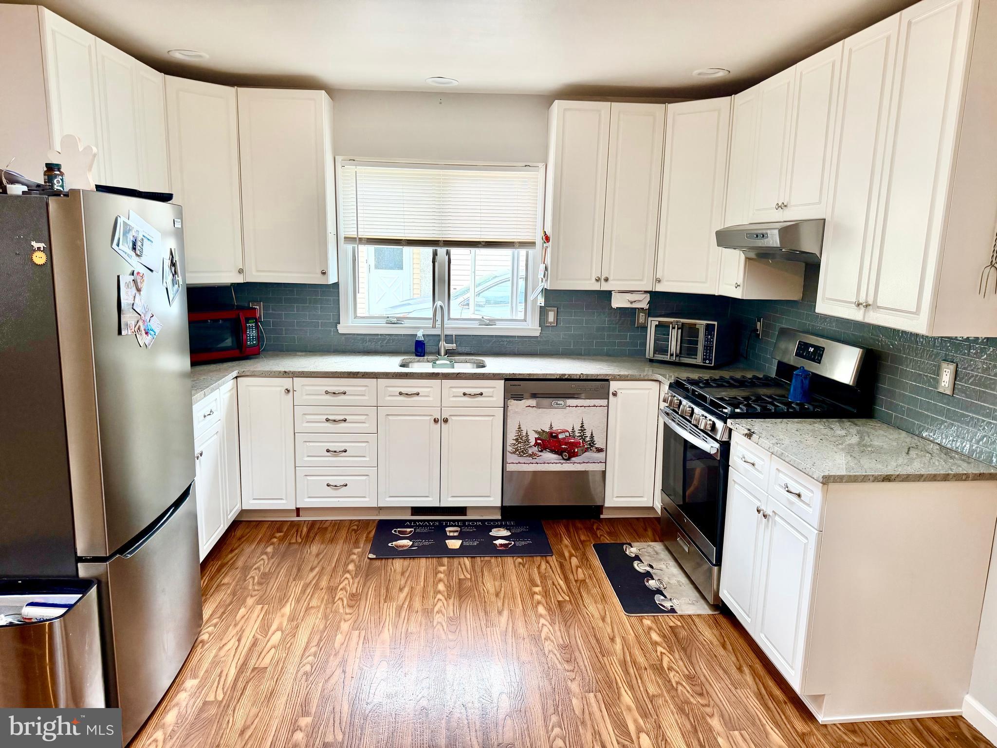 280 Progress Street Riverside, NJ 08075 - Photo 12 of 20 a kitchen with a refrigerator a sink and wooden floors