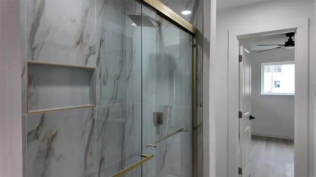 a bathroom with a shower and a glass door
