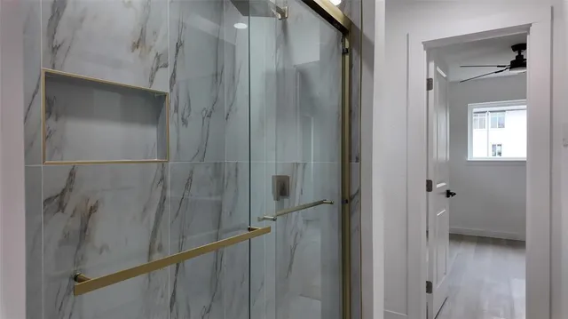 a bathroom with a glass shower door