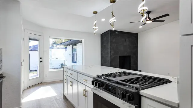 a kitchen with stainless steel appliances granite countertop a stove and a refrigerator