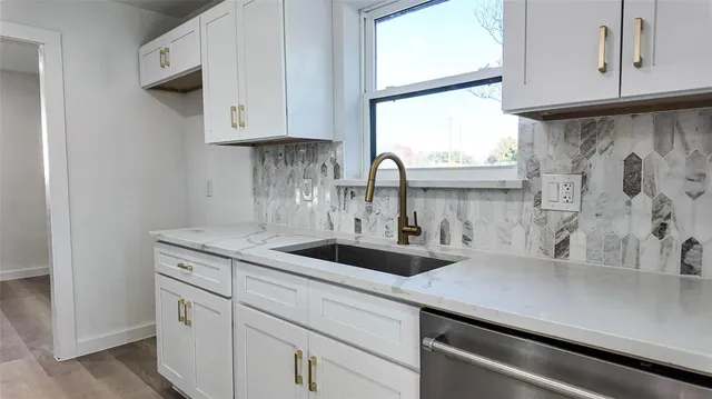 a kitchen with appliances cabinets and a window