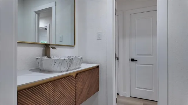 a bathroom with a sink and a mirror