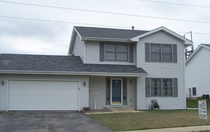 5428 Torque Road Loves Park, IL 61111 - Photo 1 of 5 a front view of a house with garage