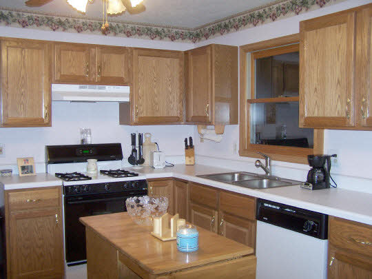 5428 Torque Road Loves Park, IL 61111 - Photo 5 of 5 a kitchen with a sink a stove and cabinets