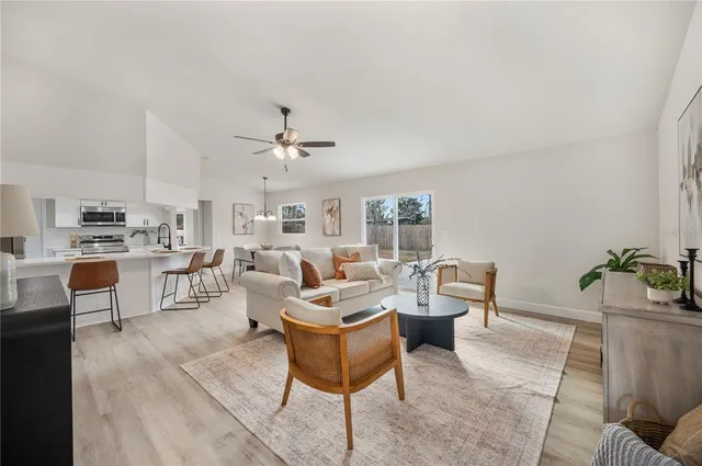 a living room with furniture and view of kitchen