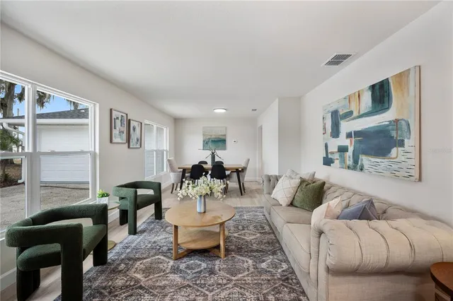 a living room with furniture potted plant and a window