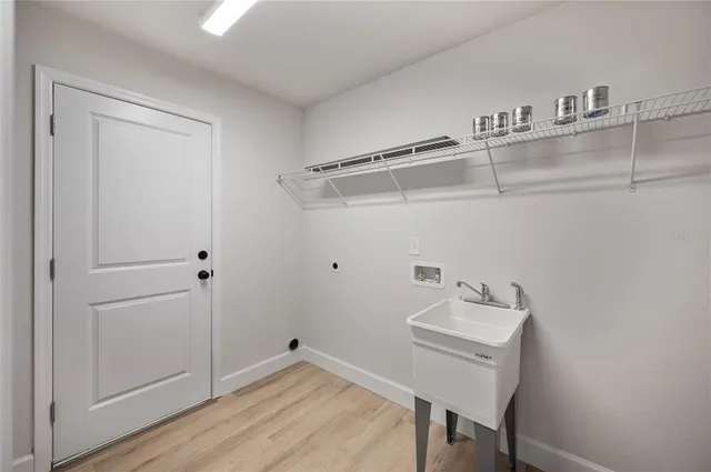 a front view of house with yard and trees in the background