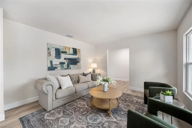 a living room with furniture and a potted plant