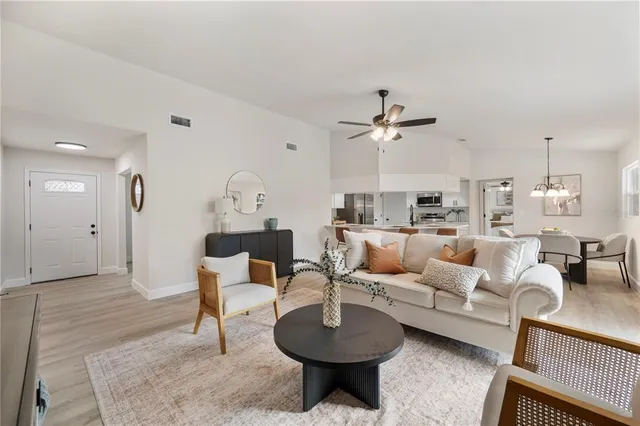 a living room with furniture a rug and a chandelier