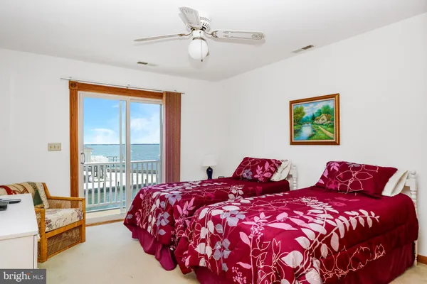 a bedroom with beds and a large window