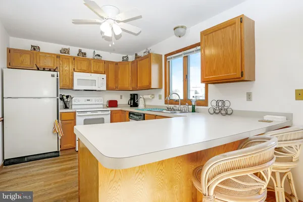 a kitchen with stainless steel appliances a refrigerator a sink and a stove