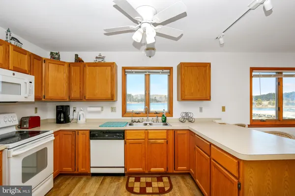 a kitchen with stainless steel appliances a sink stove and cabinets
