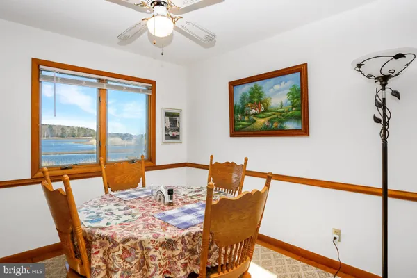 a dining room with furniture a chandelier and wooden floor