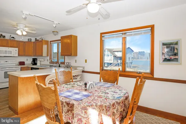 a view of a dining room with furniture a chandelier and wooden floor