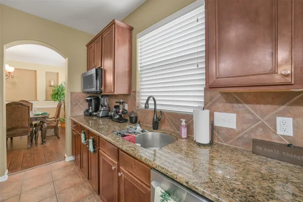 a living room with furniture a flat screen tv and a large window