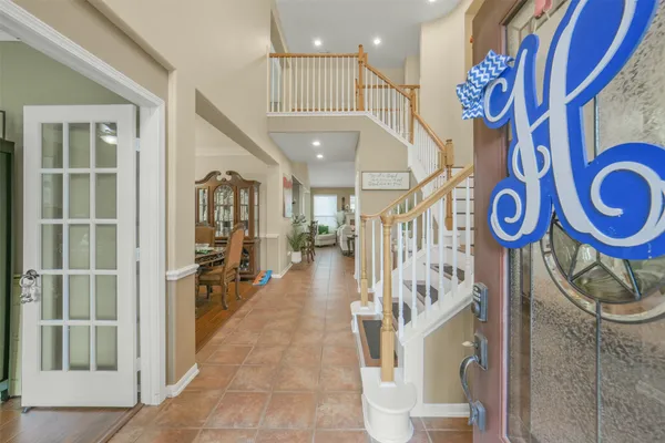 a kitchen with a stove a sink a center island and living room view