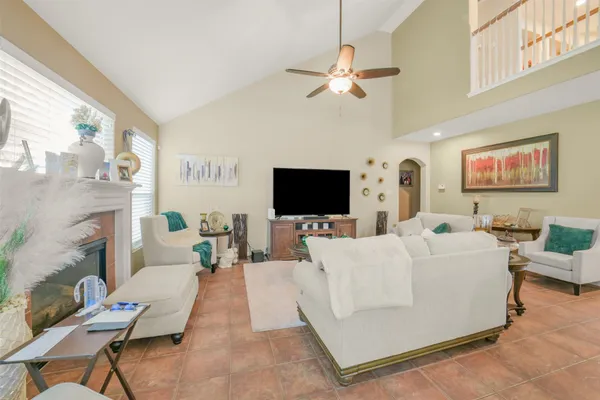 a dining room with wooden floor a chandelier a wooden table and chairs