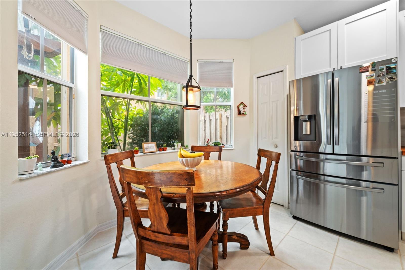 16634 Southwest 79th Terrace Miami, FL 33193 - Photo 12 of 25 a view of a dining room with furniture large window and refrigerator